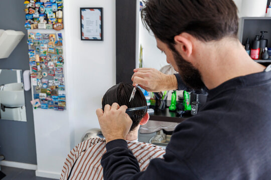 Detail shot of clipper work and clean finishing, highlighting precision grooming, professional tools, and routine maintenance in a modern shop.