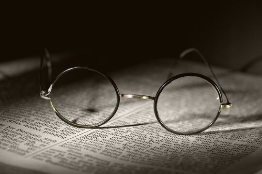 Old reading glasses on old book