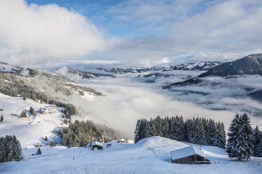 View of Alps and cloud cover over Inn Valley, ski resort, Brixen im Thale, Tyrol, Austria