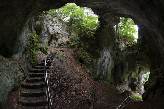 Riesenburg cave, natural karst cave ruin of Frankendolomite, geotope, natural monument, in the back climber at rock face, near Engelhardsberg, district of Markt Wiesenttal, Upper Franconia, Franconian Switzerland, Franconia, Bavaria, Germany