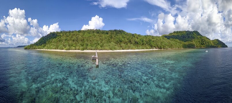 Fringing reef, jetty and beach in front of Selayar Dive Resort, Selayar Island, South Sulawesi, Indonesia