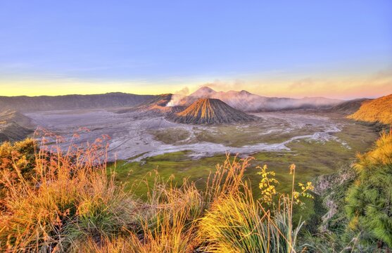 Sunrise, smoking volcano Mount Bromo, Mt. Batok at front, Mt. Kursi at back, Mt. Gunung Semeru, Bromo Tengger Semeru National Park, Java, Indonesia