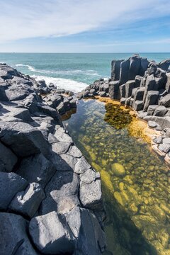 Water gathering between rocks, Roman Bath, Hexagonal basalt column by the Sea, Blackhead, Dunedin, Otago, South Island, New Zealand