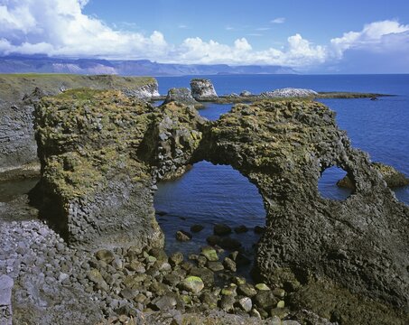 Rock gate at the cliffs formed by volcanic basalt columns in Arnarstapi, Snaefellsnes Peninsula, Iceland