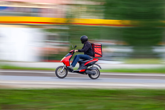 Online shopping and food delivery, technology and lifestyle, A courier on his way on a scooter.