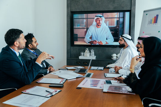 Multiethnic business team participating in virtual conference call in dubai office