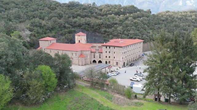 Aerial drone view of the stone exterior facade of Santo Toribio Monastery in Potes Cantabria Spain on a sunny day