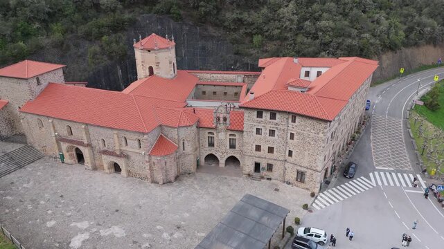 Aerial drone view of the stone exterior facade of Santo Toribio Monastery in Potes Cantabria Spain on a sunny day