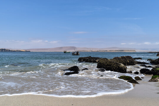 border sea with rocks in beach paracas peru, sky blue
