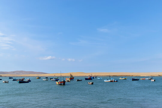 Paracas, Peru - October 2023 - Fishing boats on sunny summer day in Paracas cloudy day