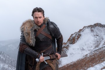 A rugged warrior stands resolute against a bleak, snowy landscape, sword at his hip and fur-trimmed armor shielding him from the elements. © horimono