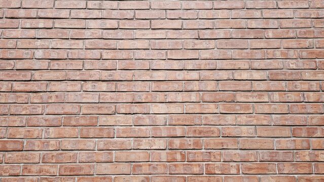 A close up view of a red brick wall with horizontal pattern