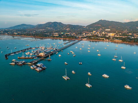 Aerial drone view of Chalong pier with many boats at sunrise, Phuket, Thailand