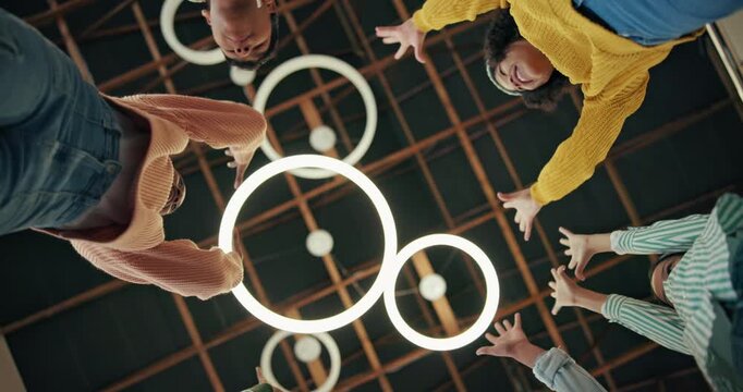 Team, fist bump from below and excited in building for success, goal and collaboration at school. Kids, hands in circle and students on stage for project, concert and huddle for energy or development