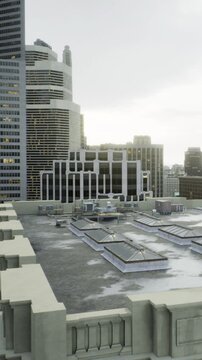 A high view of a city rooftop showing buildings in the background. The scene shows various rooftops and equipment scattered. It is daytime with overcast skies.