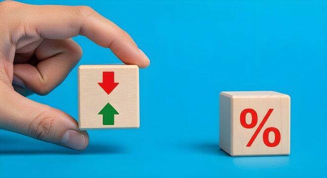 Hand holding wooden block with arrows, next to percentage block on blue background, symbolizing change and finance concepts.
