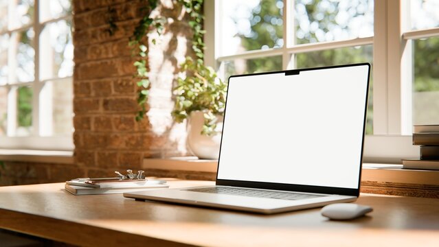 Laptop blank screen mockup in industrial loft workspace, front view