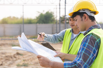 Builder team, foreman asian young engineer, architect man, male are discussing construction drawing...
