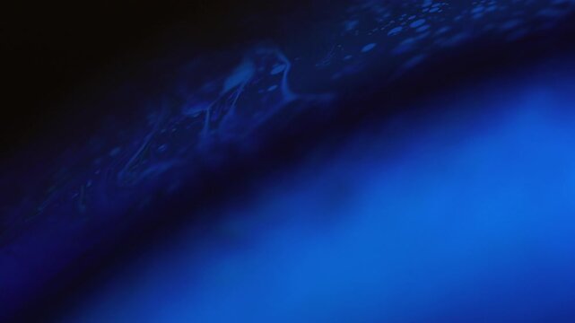 Abstract Dark Surreal Macro of Shifting Deep Blue Liquid with Eerie Glow
