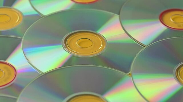 Many compact discs for laser players shimmer with rainbow colors.