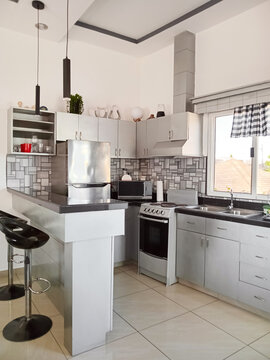 Clean kitchen area with bar counter and appliances