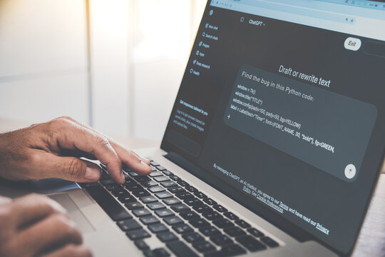 Milan, Italy 3/19/2026 Programmer hands typing on laptop keyboard using ChatGPT artificial intelligence software to find bugs in Python code for modern software development and debugging process
