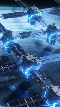 Vertical video: Igniting sat cluster sparking blue arcs in orbit near solar arrays powering rings
