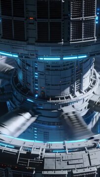 Vertical video: Motor starting ring rotation, center column moving pods past camera for tech check