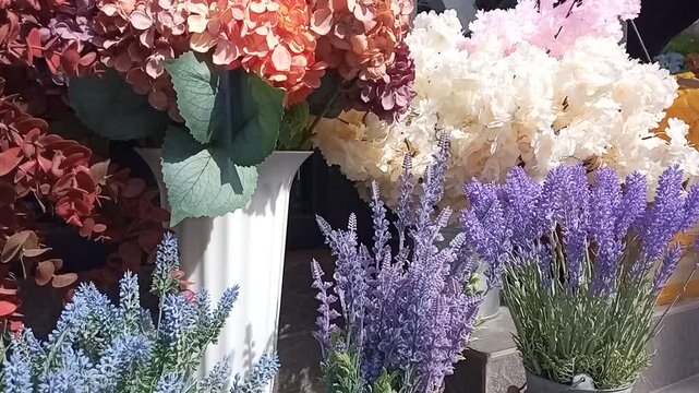 dense bouquets of various flowers in vases