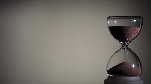 Hourglass flowing on white background. Right align comp with copy space on top and left, time management concept, minimalist product shot, hourglass in motion, clean style, approaching end
