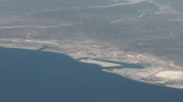 aerial view of Saudi Arabian landscape, in Oxagon, Al Muwaileh, located at Red Sea coastline with Port of NEOM, Lagoon Duba and Muwaleih and mountain desert landscape in the background- 4k footage