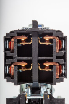 Top-down close-up of an air compressor pressure switch, showing the black plastic housing with technical specifications, a red round on-off power button, and a pressure regulator knob.