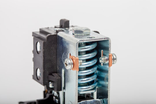 Top-down close-up of an air compressor pressure switch, showing the black plastic housing with technical specifications, a red round on-off power button, and a pressure regulator knob.