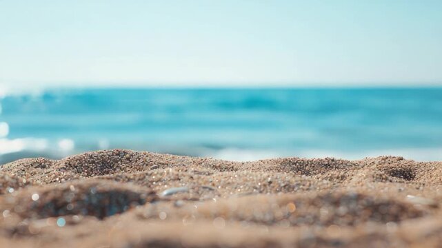 Video A serene scene of a sandy beach with a calm blue ocean in the background, perfect for relaxation and vacation themes