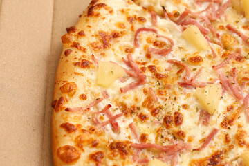 Pizza with ham and pineapple close up. Fast food concept. Baked meal background. Restaurant...