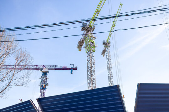 Russia. Moscow. March 22, 2026. High rise construction site with ZTM tower cranes against clear sky