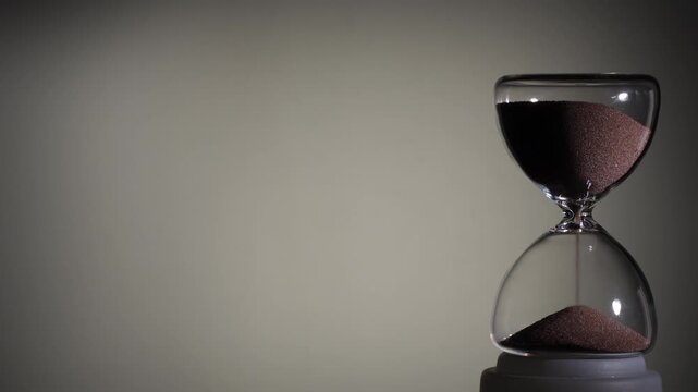 Hourglass flowing on white background. Right align comp with copy space on top and left, time management concept, minimalist product shot, hourglass in motion, clean style, steady flow
