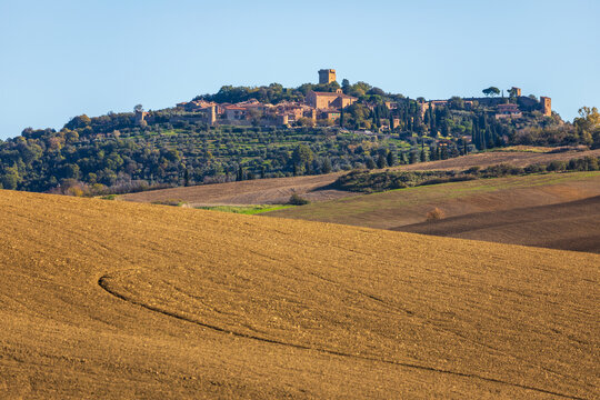 Tuscan hill town Pienza with plowed fields, Italy.