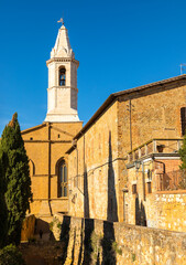 Naklejka premium Pienza Duomo bell tower and historic buildings in Tuscany, Italy.