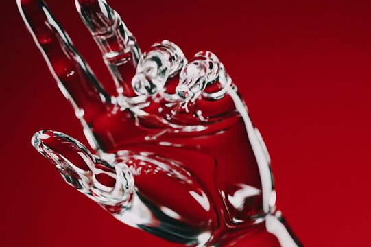 Glazed glass hand gesture against a vibrant red backdrop