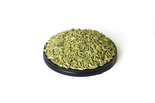 fennel seeds - saunf variyali on small round black color plastics tray isolated on white background