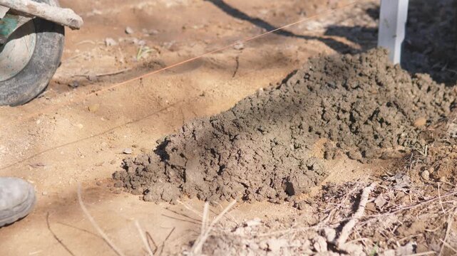 Surface Smoothing And Preparation In Progress. Closeup Of Workers Guiding Concrete Mixture Along String Line. Detail Of Surface Texture And Screeding Process During Concrete Work On Site