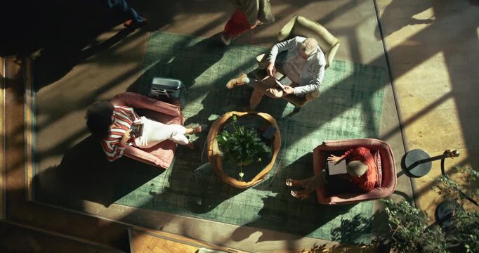 Above, office and business people on sofa with team for meeting, planning and startup. Professional lobby, creative agency and top view of men and women for conversation, discussion and collaboration