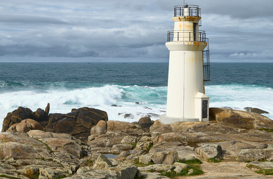 Mux&iacute;a Lighthouse. Mux&iacute;a (Spain), March 15, 2026. This small lighthouse is located on Punta da Barca, on the Costa da Morte (Coast of Death), a few meters from the Sanctuary of Our Lady of the Boat