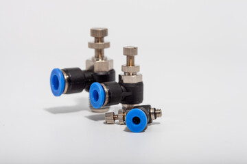 Pneumatic speed control fittings with blue push-to-connect rings and adjustable needles for precise...