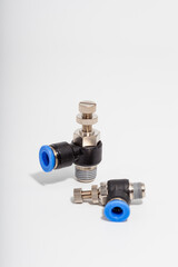 Pneumatic speed control fittings with blue push-to-connect rings and adjustable needles for precise...