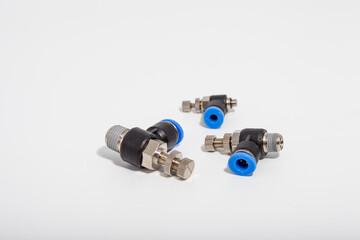 Pneumatic speed control fittings with blue push-to-connect rings and adjustable needles for precise...