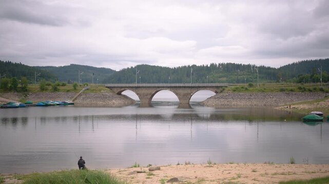 Fisherman at Schluchsee Blackforest Germany with Stonebridge for trains
