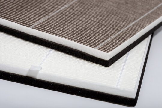 Macro view of pleated HEPA and carbon air filters with foam gaskets for HVAC systems, air purifiers, and industrial ventilation maintenance