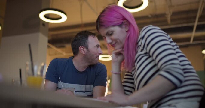 Model discusses creative concepts with colleague in modern workspace